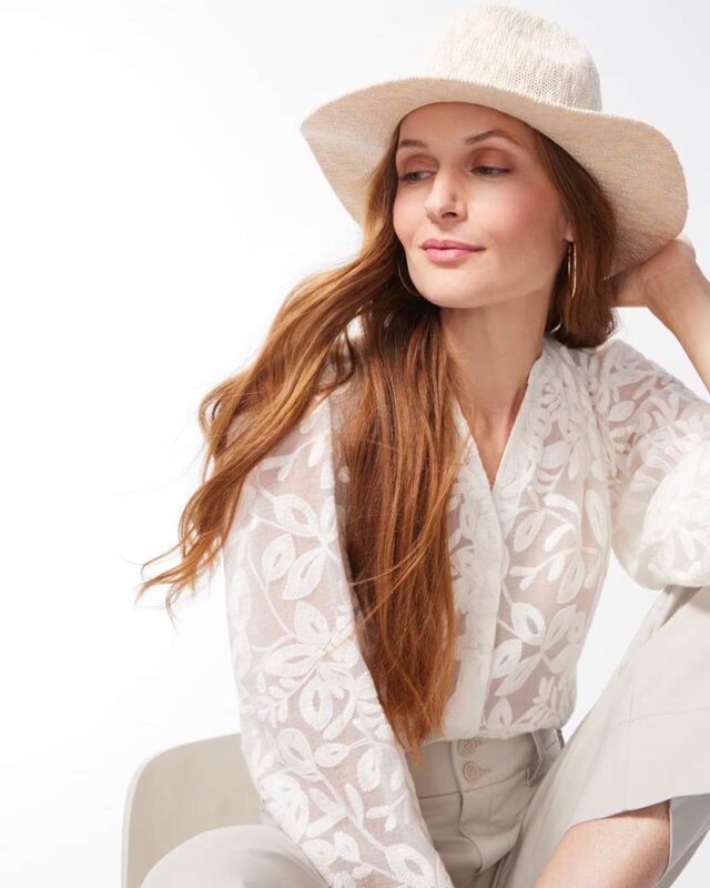 WHBM model wearing a light colored blouse with a hat