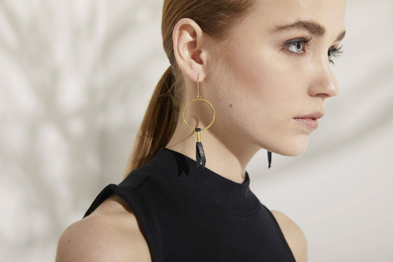 Model wearing gold earrings