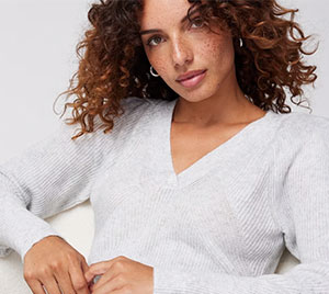 Fashion model in a white sweater looking into camera