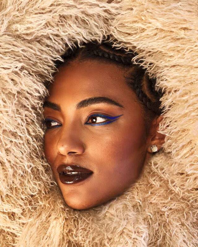 Model face surrounded by fluffed fabrics