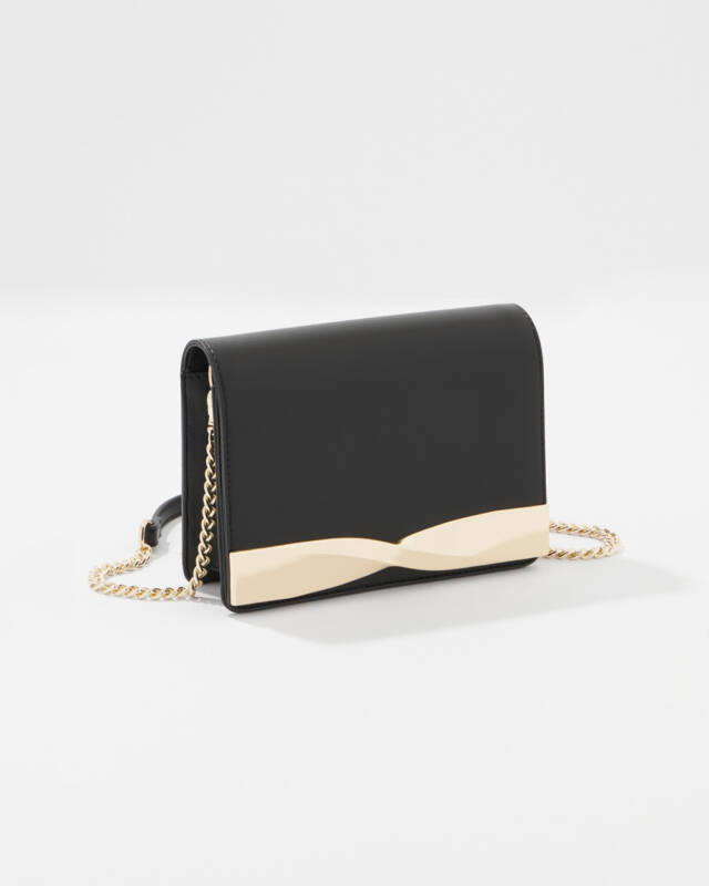 black leather clutch with a gold wave-shaped metal accent and a gold chain strap