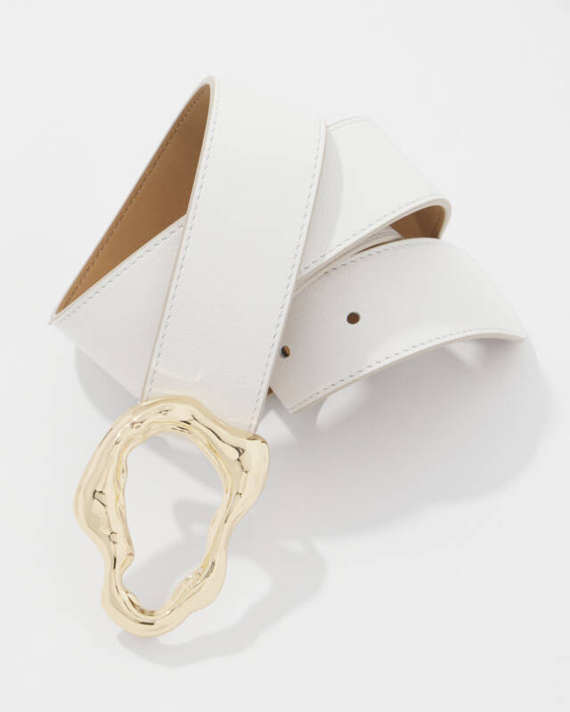 white leather belt with a large irregular gold-tone buckle laying on its side