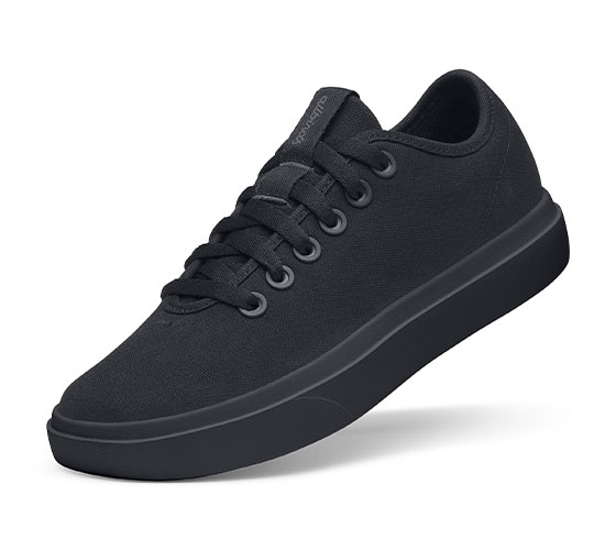 black low-top sneaker with a chunky platform sole and laces, shown at a slight angle.
